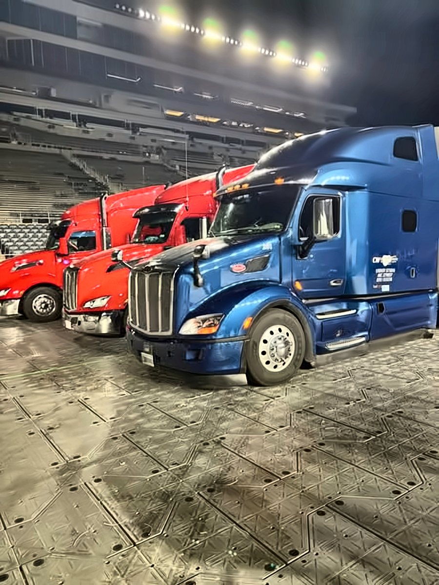 Blue CW Peterbilt inside a stadium